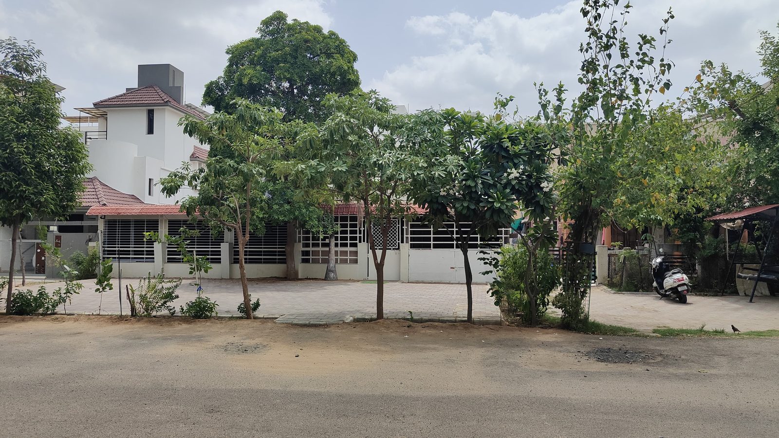 Smart Kids school building with trees and paved grounds