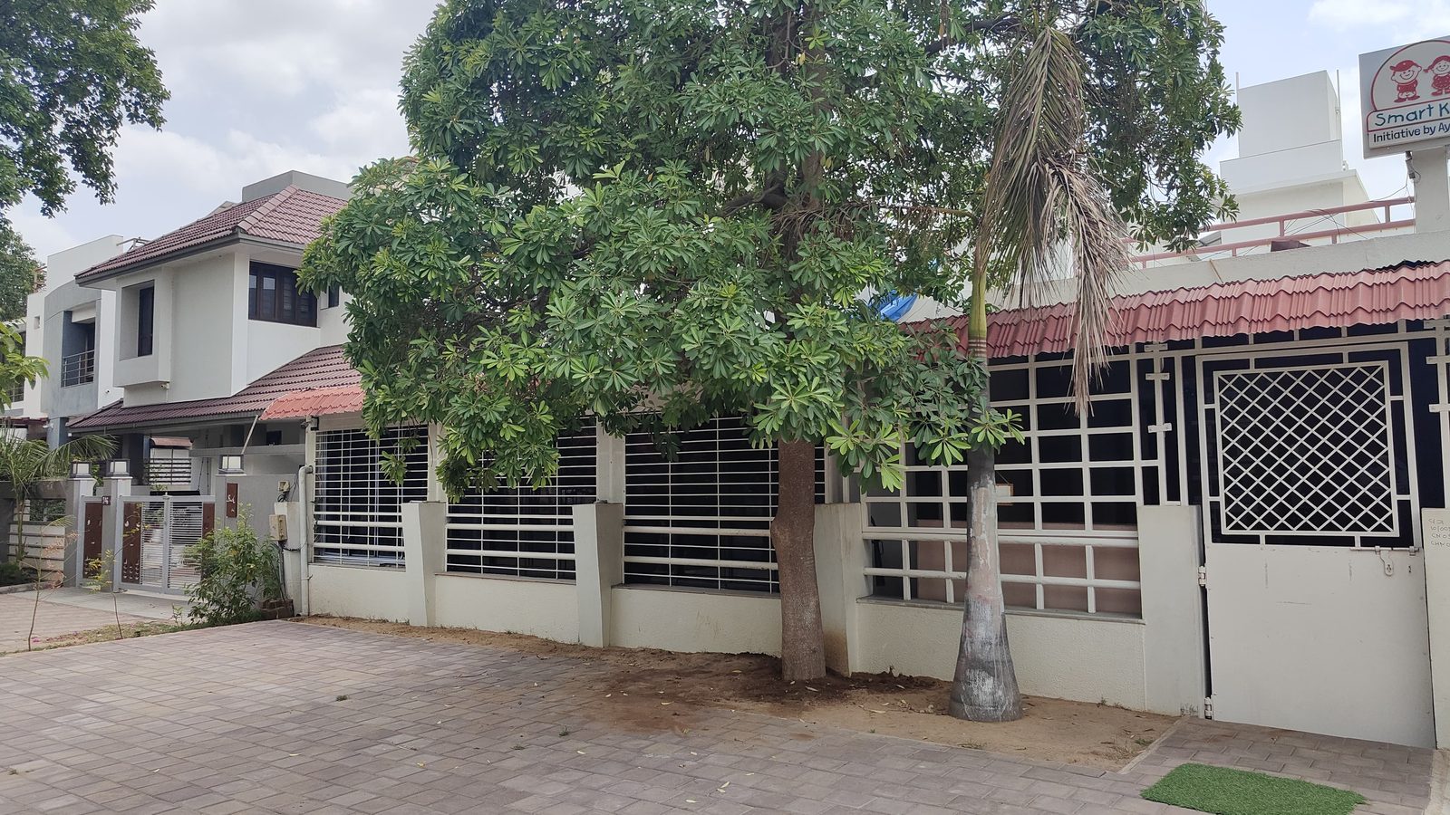 Green tree-lined surroundings beside the Smart Kids campus