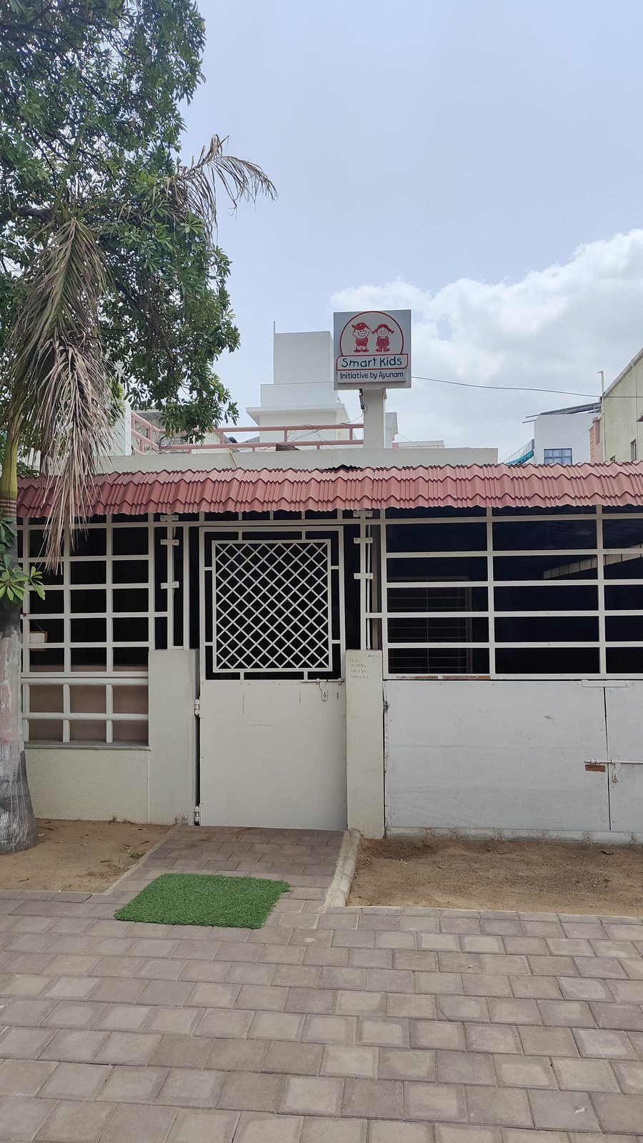 Smart Kids Nursery School entrance gate with rooftop signboard, Gandhinagar